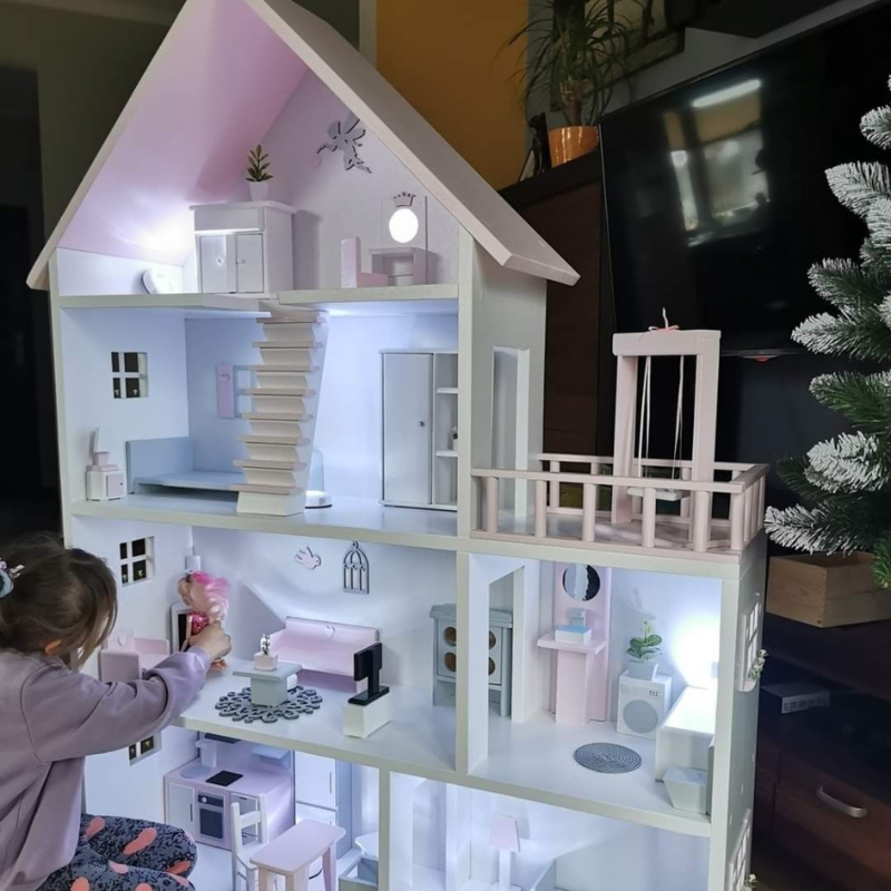 Child playing with Kiddies Kingdom dollhouse