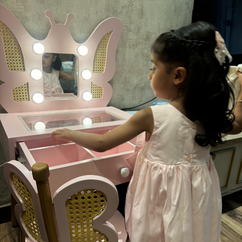 Child at butterfly vanity table